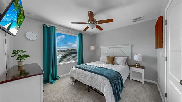a bedroom with a bed and a potted plant
