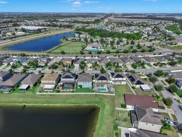 an aerial view of a city with a lake view