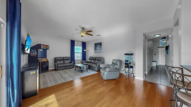a view of a dining room with furniture and wooden floor