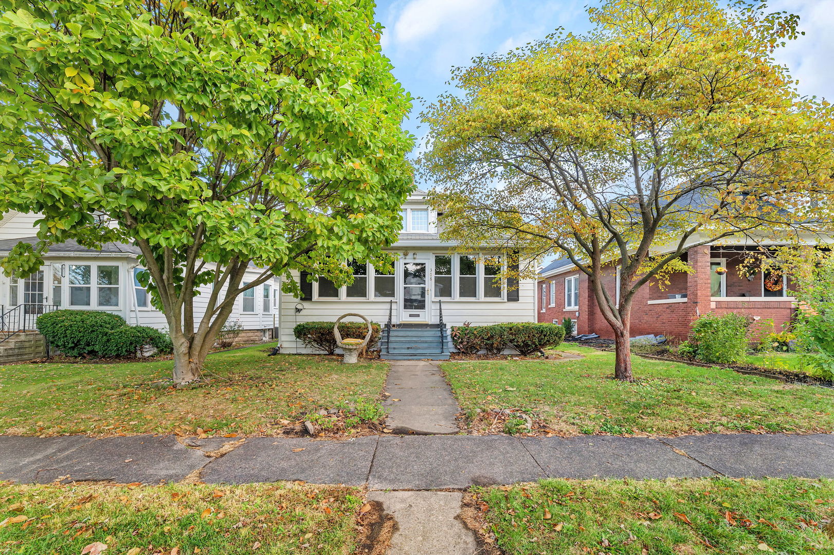 a front view of a house with garden
