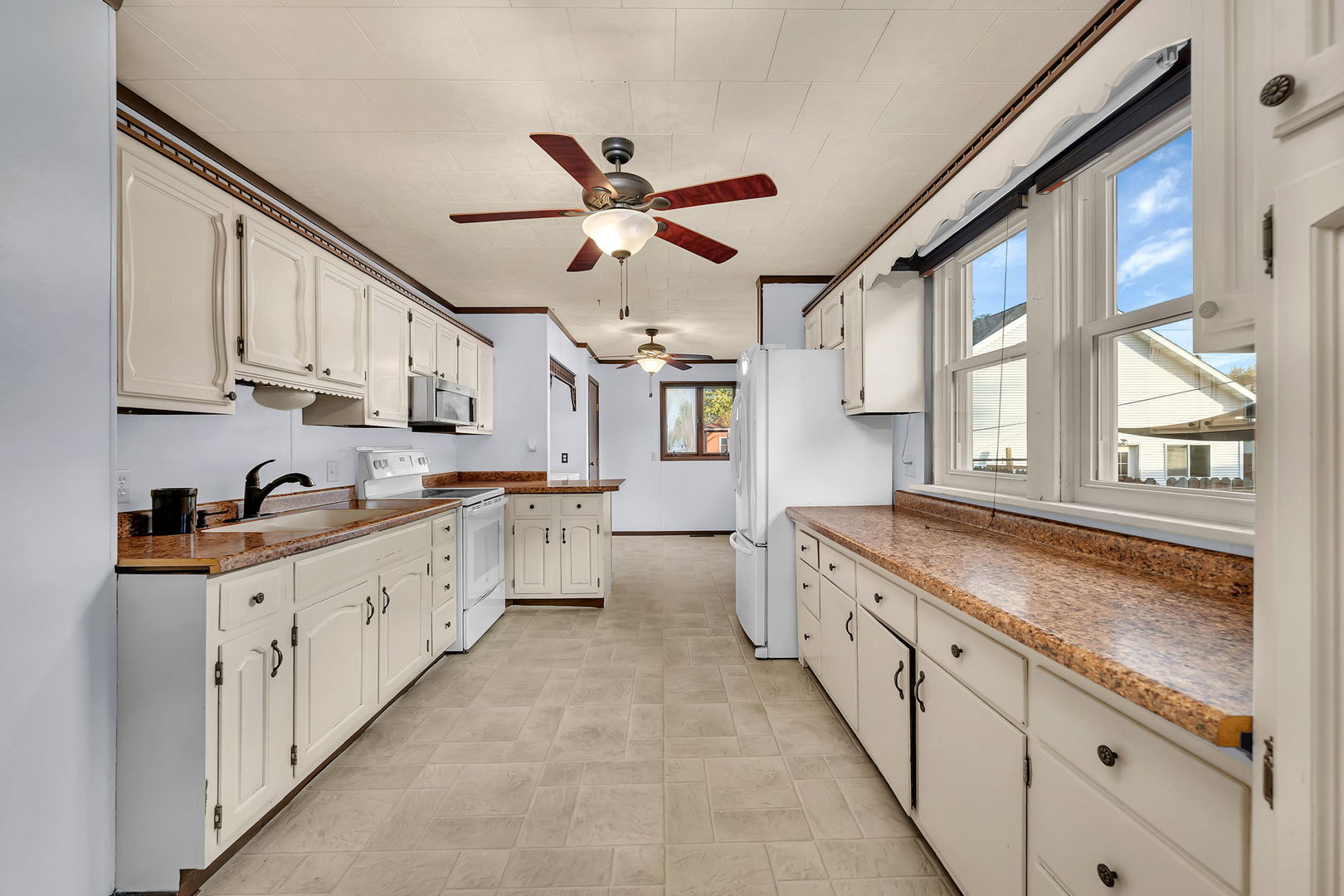 308 East Delaware Street Dwight, IL 60420 - Photo 11 of 29 a large kitchen with granite countertop a large window and white stainless steel appliances