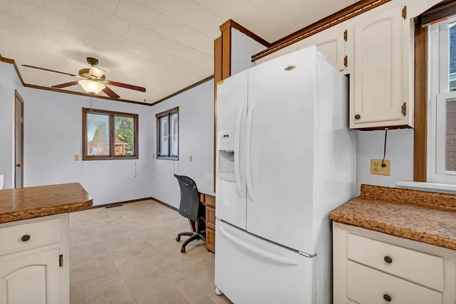a view of hallway with granite countertop cabinets and a window