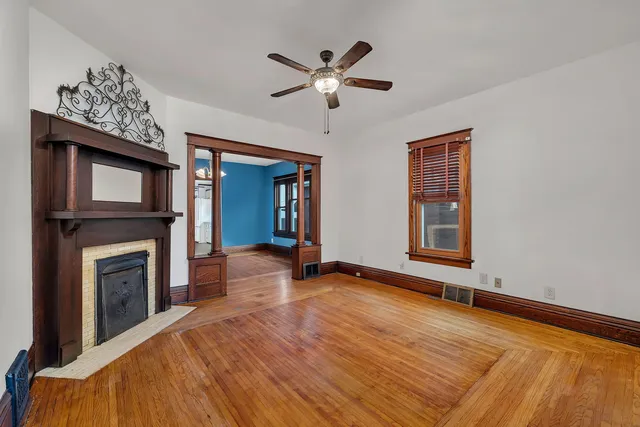 a view of an empty room with a fireplace and a window