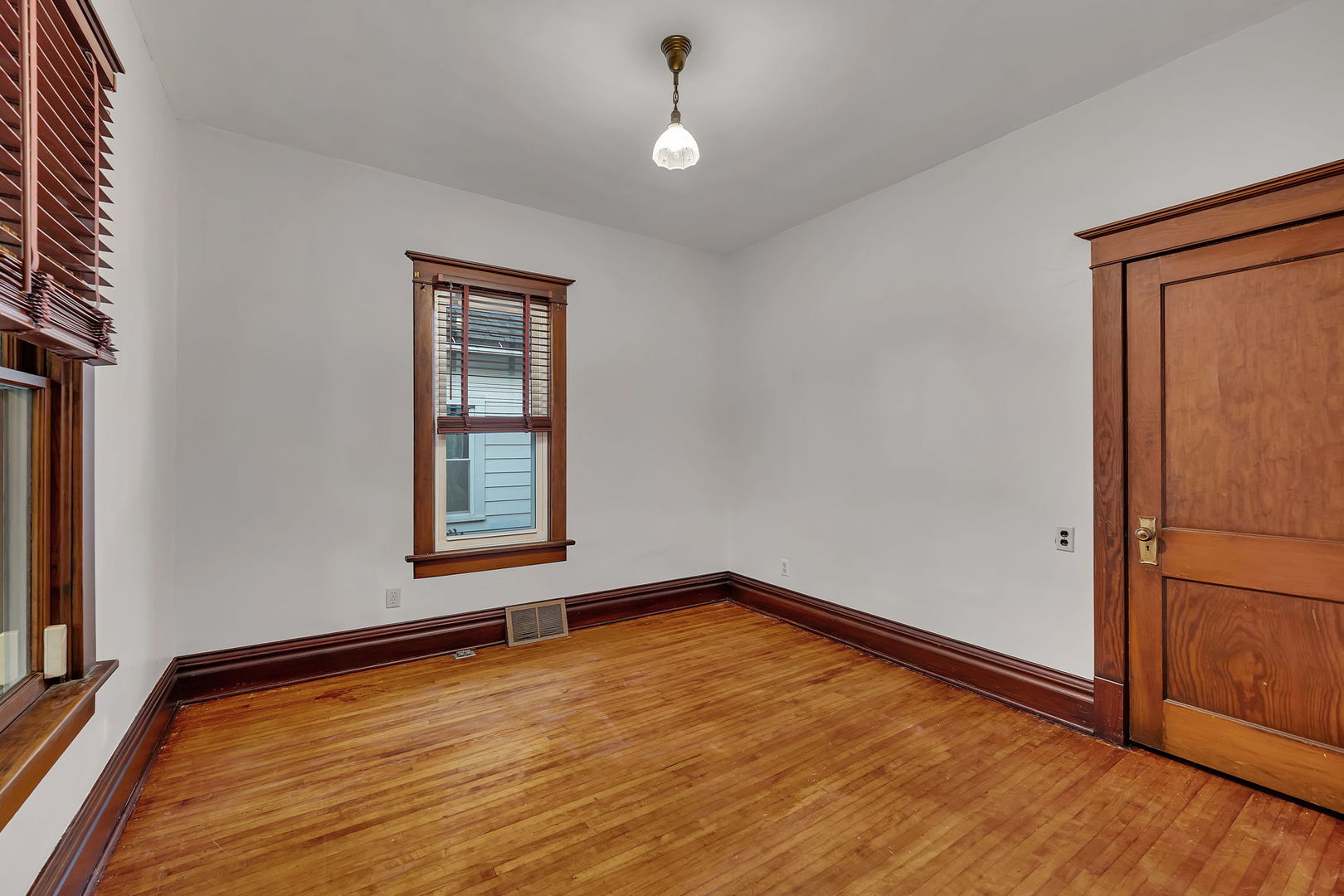 308 East Delaware Street Dwight, IL 60420 - Photo 8 of 29 a view of an empty room with window and wooden floor