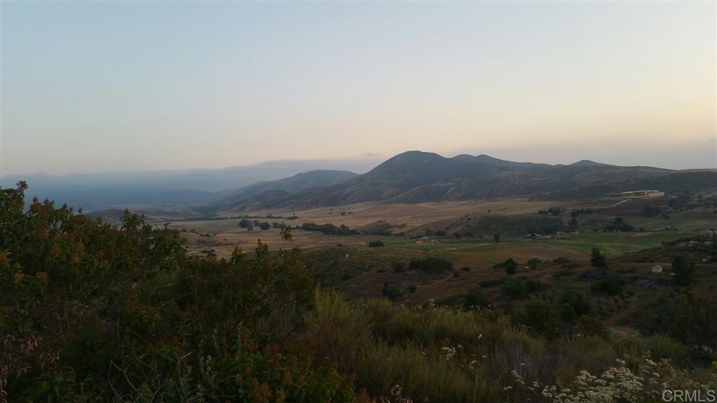 Hillside Estates Jamul, CA 91935 - Photo 21 of 24 a view of a lush green forest with mountains in the background