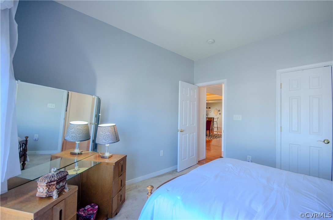 1113 Alcorn Terrace Midlothian, VA 23114 - Photo 30 of 36 a bedroom with a bed and a mirror