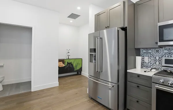a kitchen with stainless steel appliances a refrigerator and a stove top oven