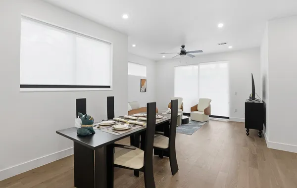 a view of a dining room with furniture and wooden floor