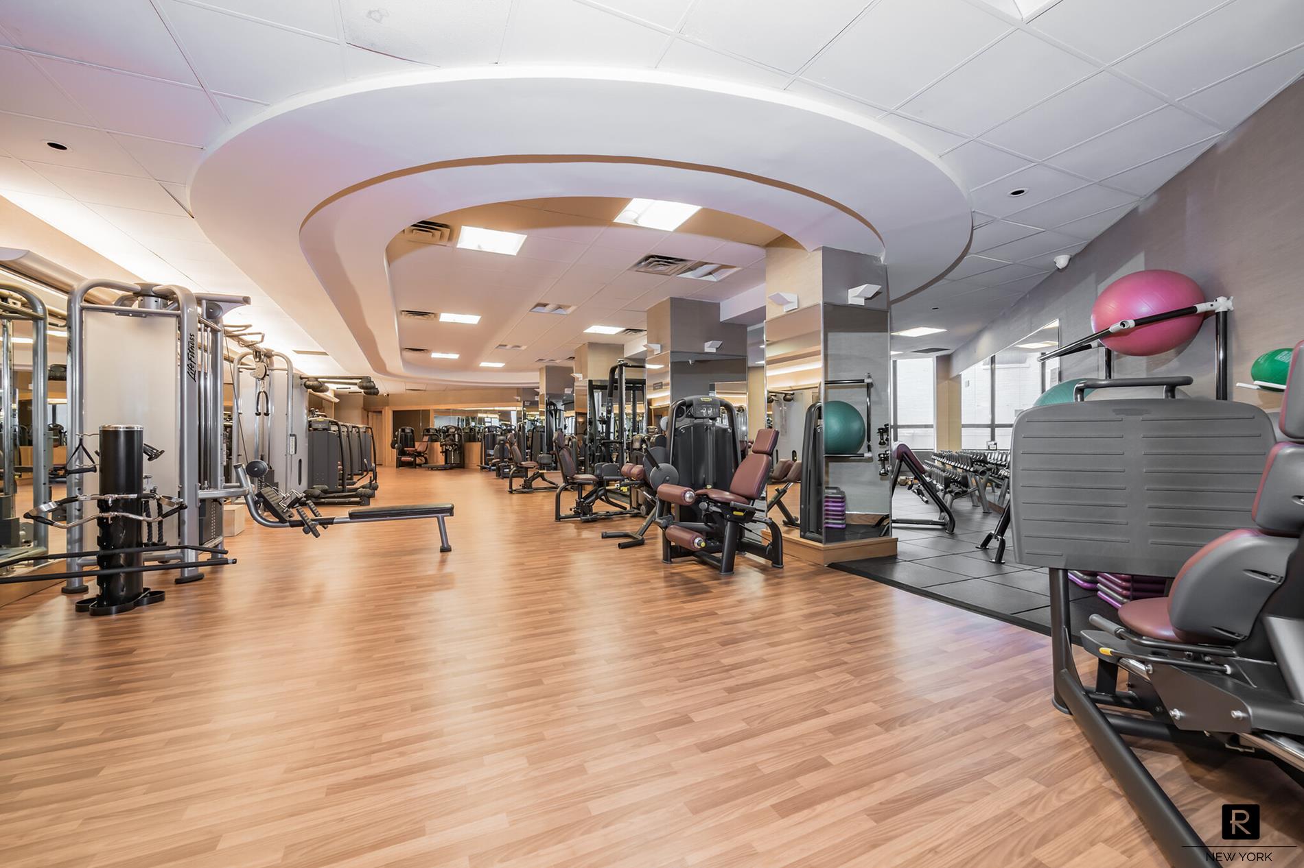 415 East 37th Street, Unit 27D Manhattan, NY 10016 - Photo 11 of 17 a lobby with furniture and wooden floor