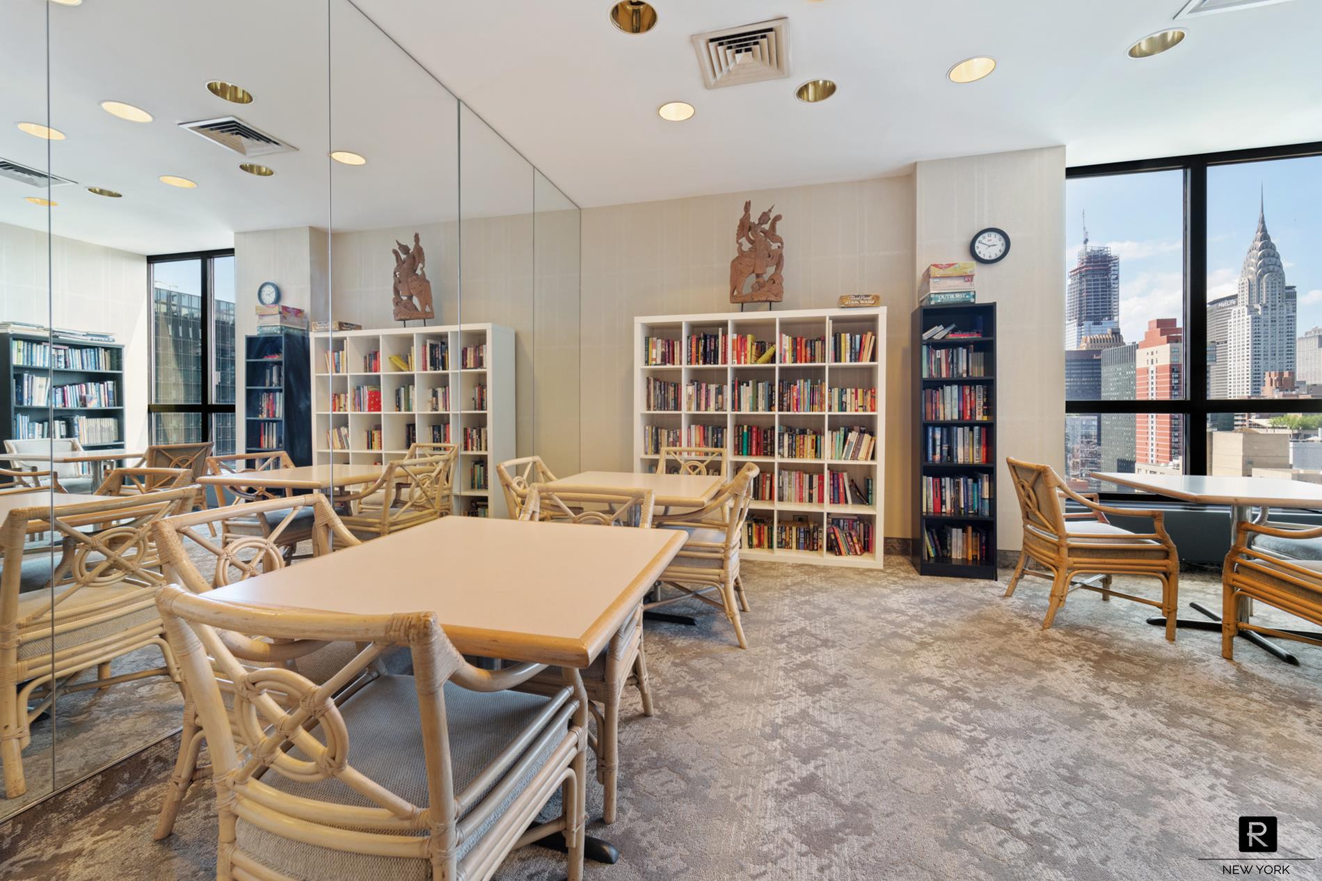 415 East 37th Street, Unit 27D Manhattan, NY 10016 - Photo 13 of 17 a view of a dining room with furniture and a bookshelf