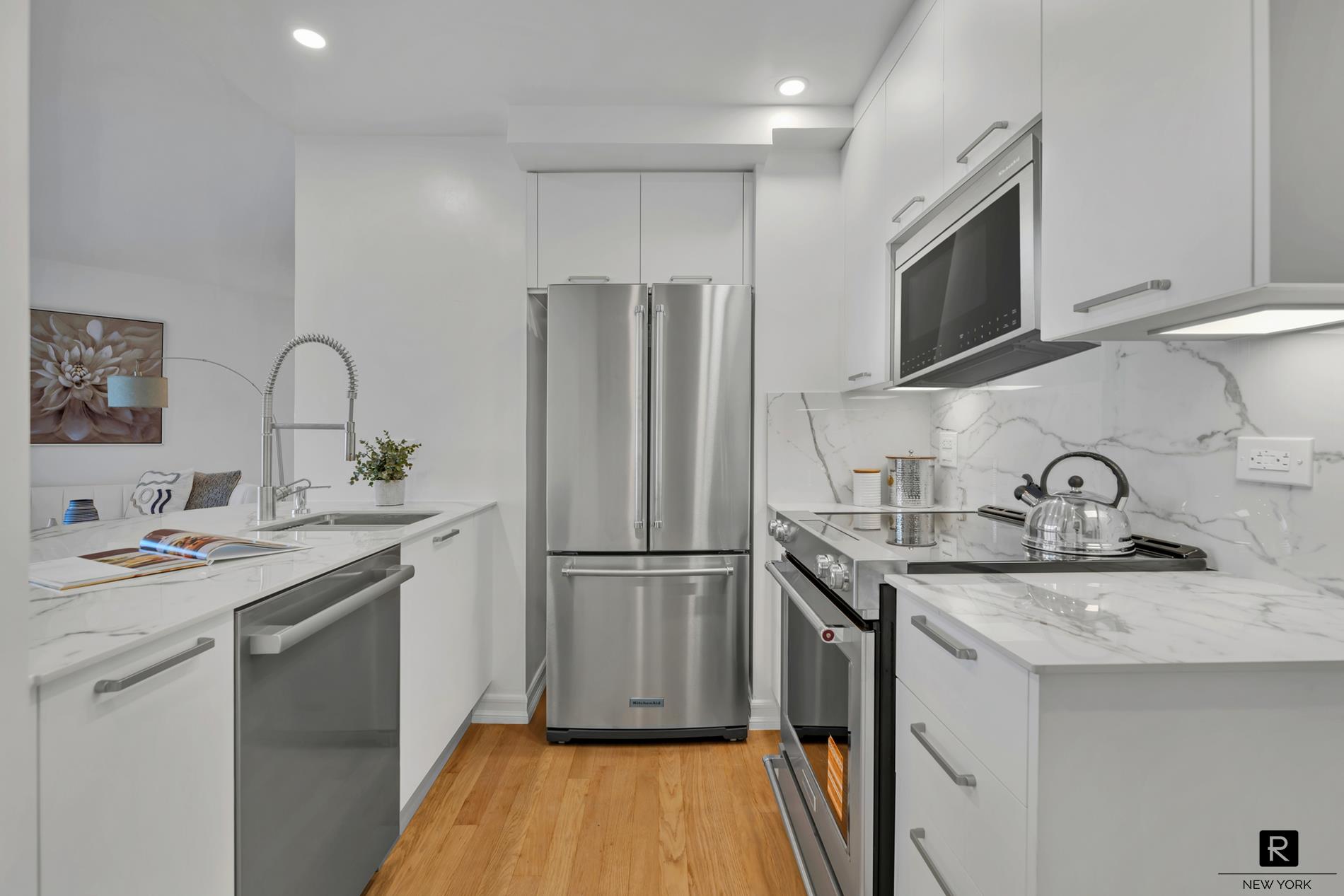 415 East 37th Street, Unit 27D Manhattan, NY 10016 - Photo 2 of 17 a kitchen with stainless steel appliances granite countertop a sink stove and refrigerator