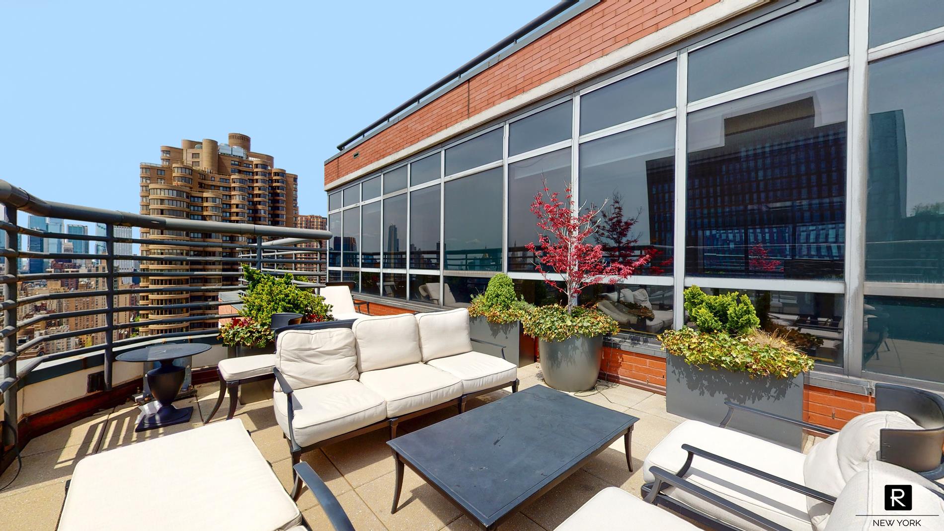 415 East 37th Street, Unit 27D Manhattan, NY 10016 - Photo 9 of 17 a view of a patio with couches table and chairs and potted plants