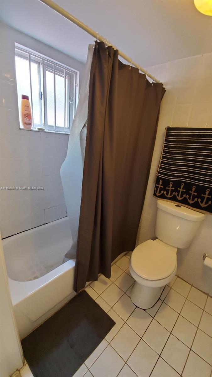 5830 West 18th Lane, Unit 101 Hialeah, FL 33012 - Photo 11 of 14 a bathroom with a toilet and a shower