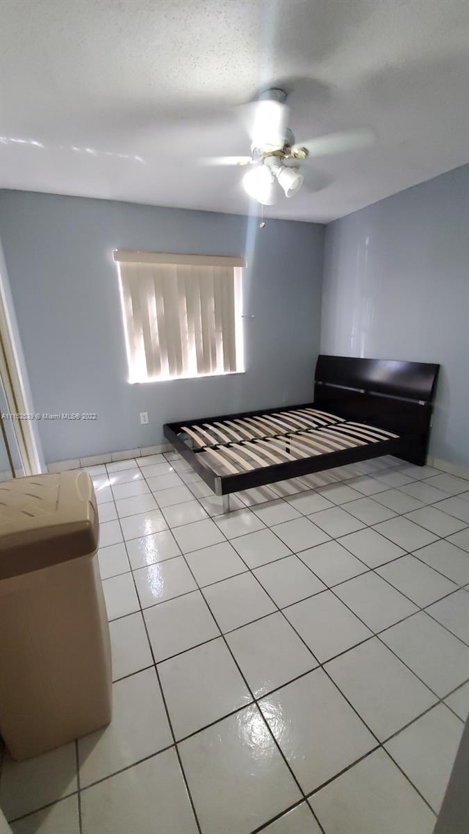 5830 West 18th Lane, Unit 101 Hialeah, FL 33012 - Photo 12 of 14 a view of an empty room and window