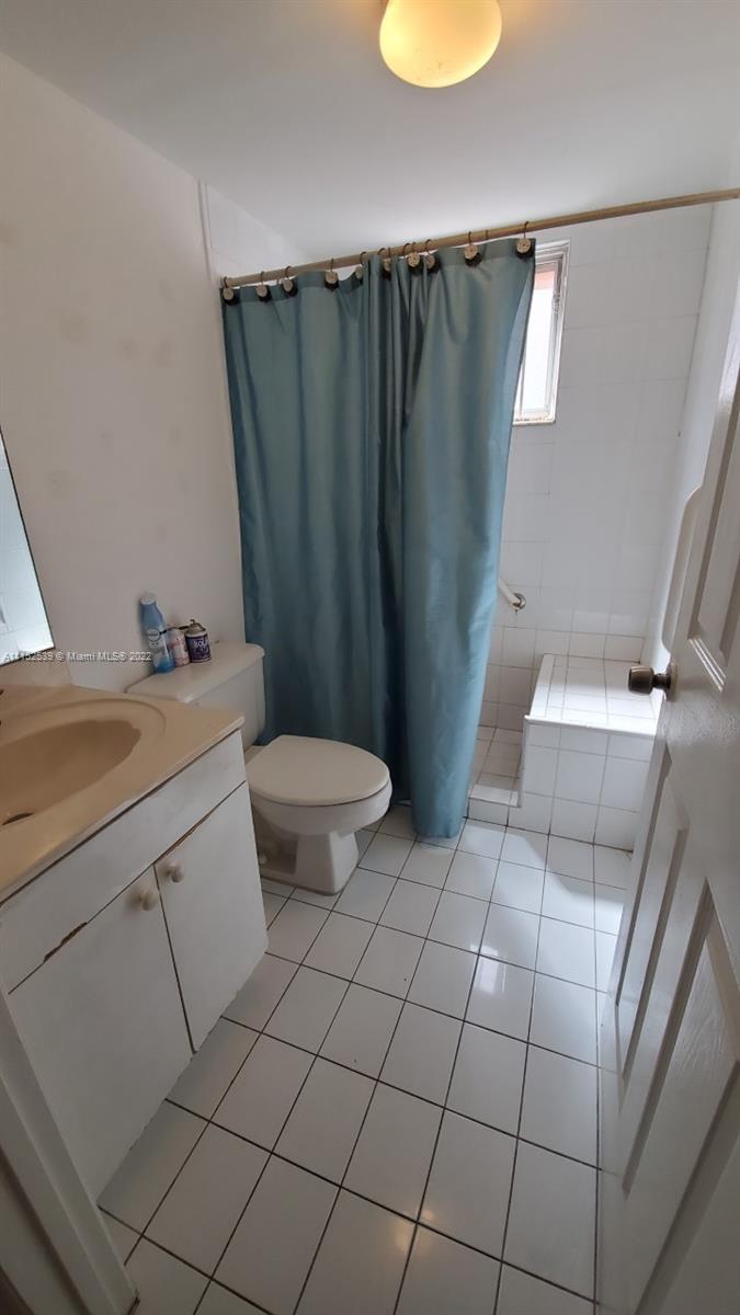 5830 West 18th Lane, Unit 101 Hialeah, FL 33012 - Photo 14 of 14 a bathroom with a sink toilet and tub