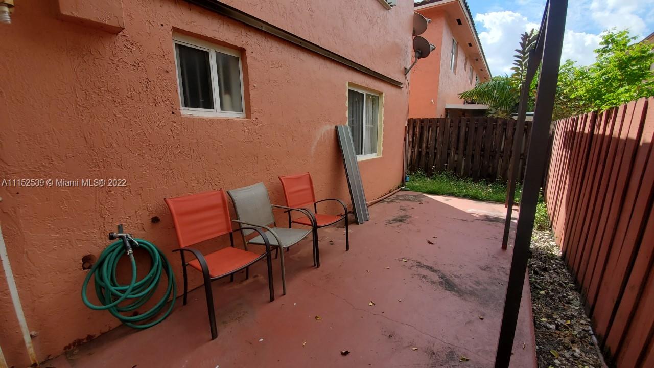 5830 West 18th Lane, Unit 101 Hialeah, FL 33012 - Photo 2 of 14 a view of a backyard with chairs and a swing