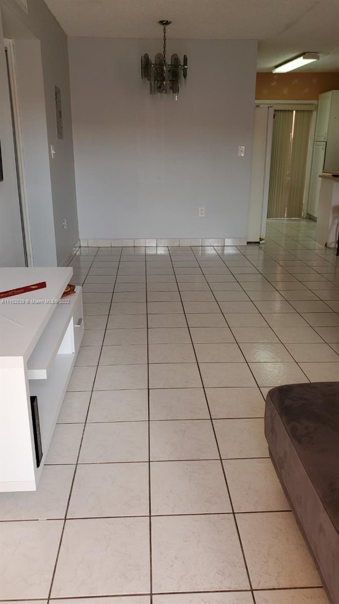 5830 West 18th Lane, Unit 101 Hialeah, FL 33012 - Photo 5 of 14 a view of a livingroom with an empty space and a sink
