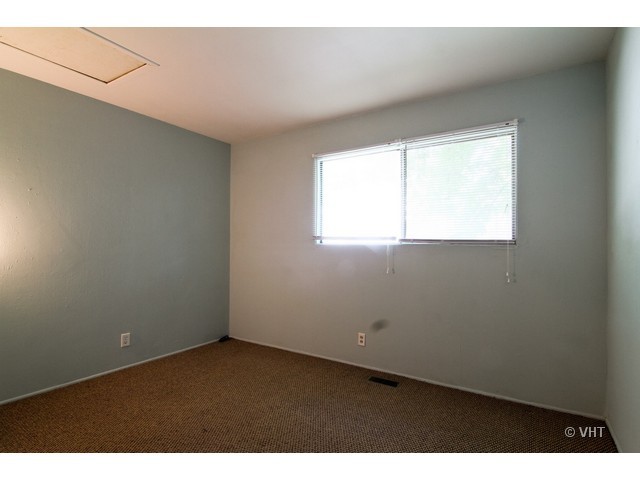67 Sierra Road Montgomery, IL 60538 - Photo 8 of 10 a view of an empty room with a window