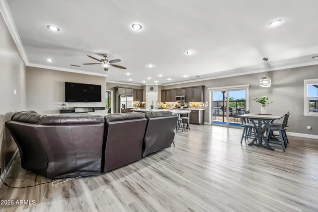 a kitchen with granite countertop a table chairs stove and microwave