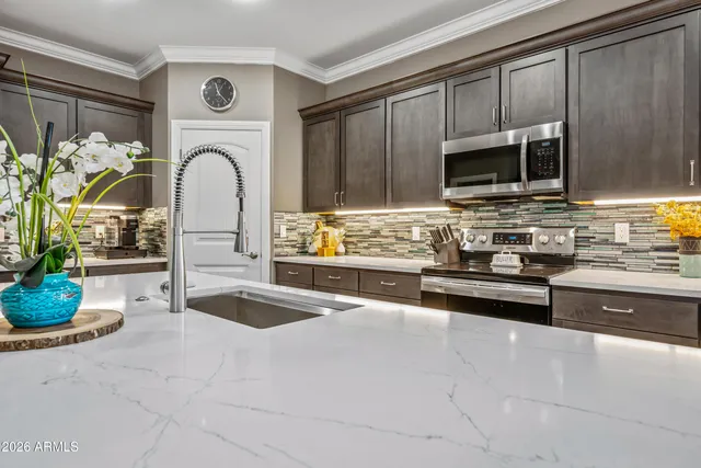 a bathroom with a sink a toilet a mirror and shower