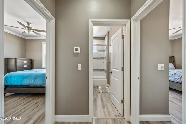 a en suite bathroom with a sink a large mirror and a shower