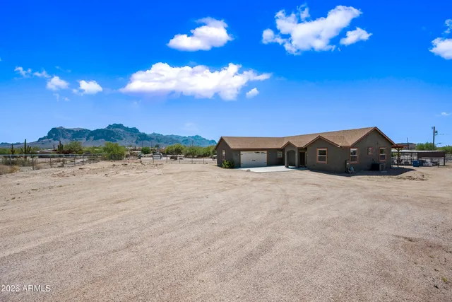 a large kitchen with lots of counter space a sink appliances and dining table
