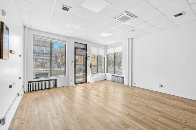 a big room with wooden floor and windows
