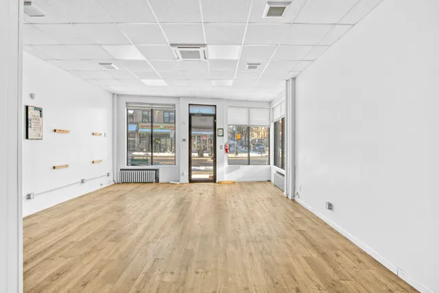 a big room with wooden floor and windows