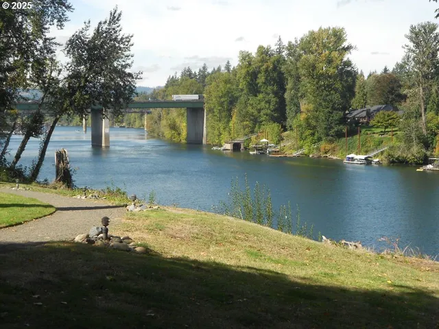 a view of a house with yard and lake view