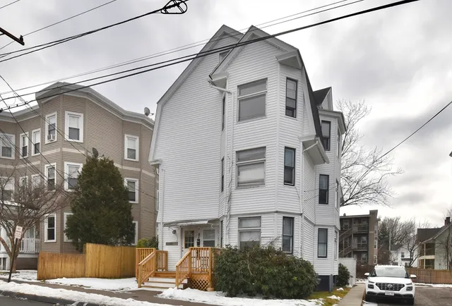 a front view of a residential houses with yard