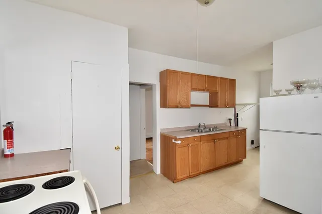 a kitchen with stainless steel appliances a refrigerator sink and cabinets