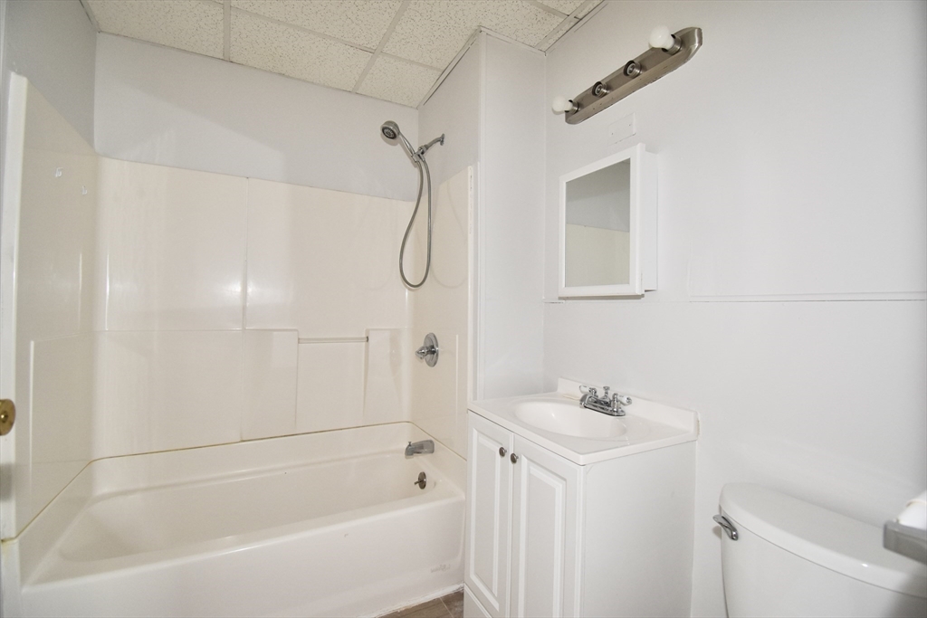 86 Cochran Street, Unit 3 Chicopee, MA 01020 - Photo 10 of 18 a white bath tub sitting next to a white sink and a shower