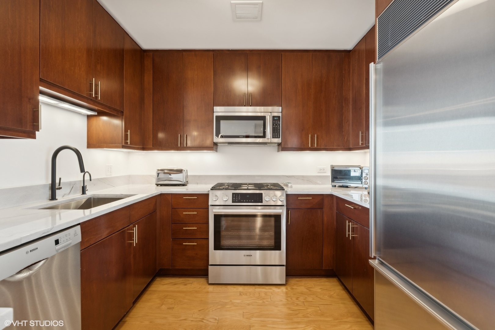 60 East Monroe Street, Unit 2903 Chicago, IL 60603 - Photo 4 of 19 a kitchen with a sink and stainless steel appliances