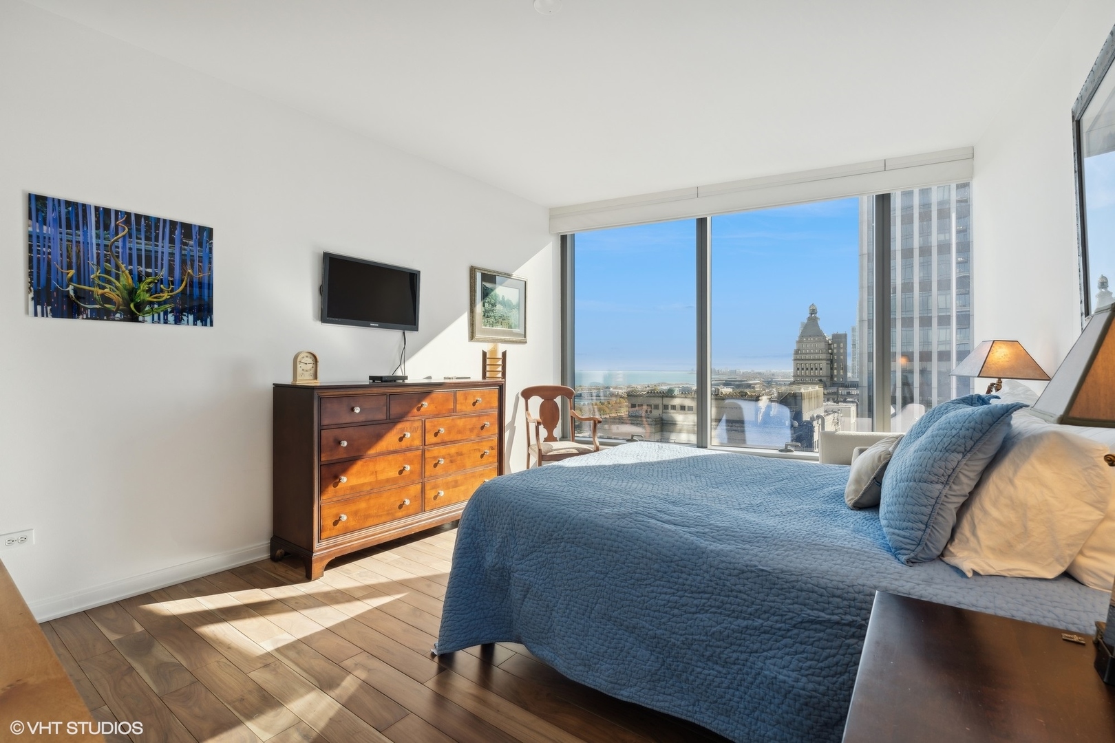60 East Monroe Street, Unit 2903 Chicago, IL 60603 - Photo 6 of 19 a bedroom with a bed and large windows