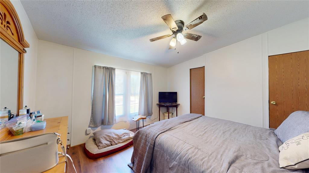 670 Arbin Culpepper Road Jonesboro, LA 71251 - Photo 7 of 17 a bedroom with a bed and a chandelier