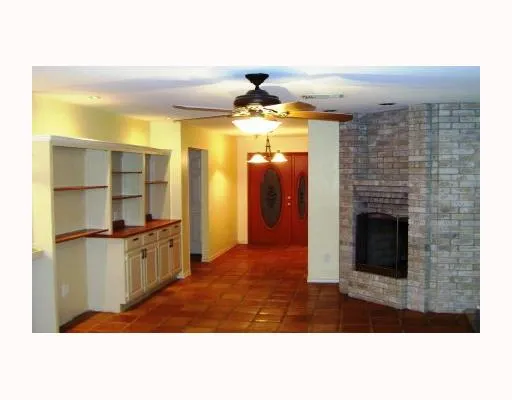 a kitchen view with fireplace and window