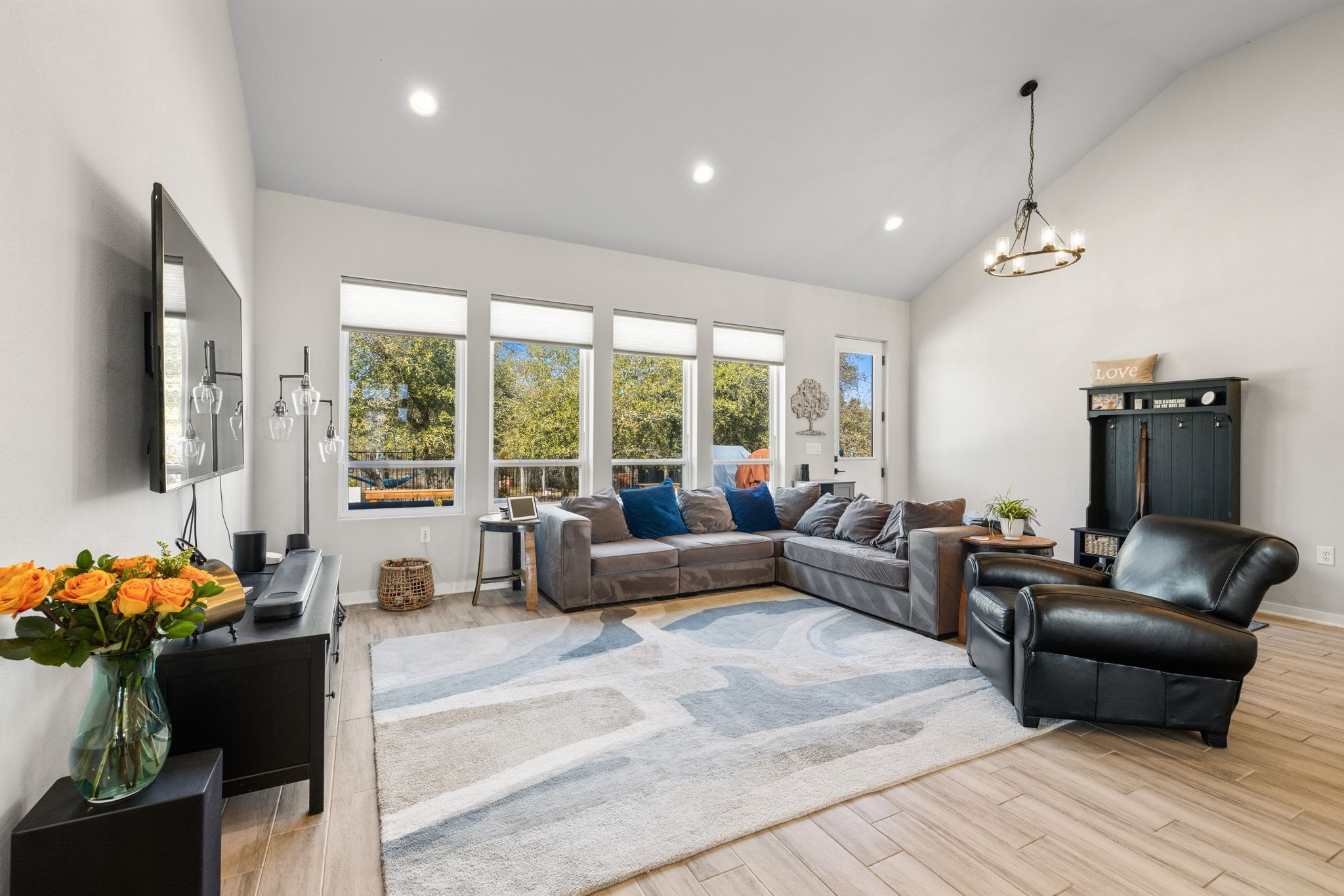 14302 Summit View Drive, Unit 4 Leander, TX 78641 - Photo 11 of 40 Living area with lofted ceiling, light wood-style floors, and hanging lights