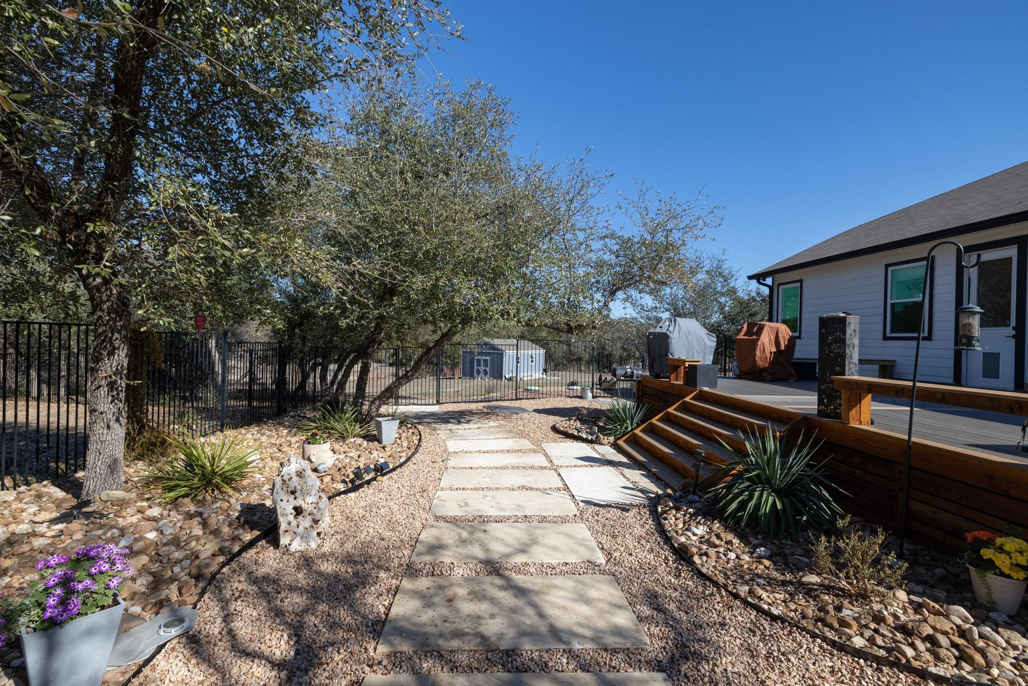 14302 Summit View Drive, Unit 4 Leander, TX 78641 - Photo 26 of 40 Fenced backyard featuring a storage unit