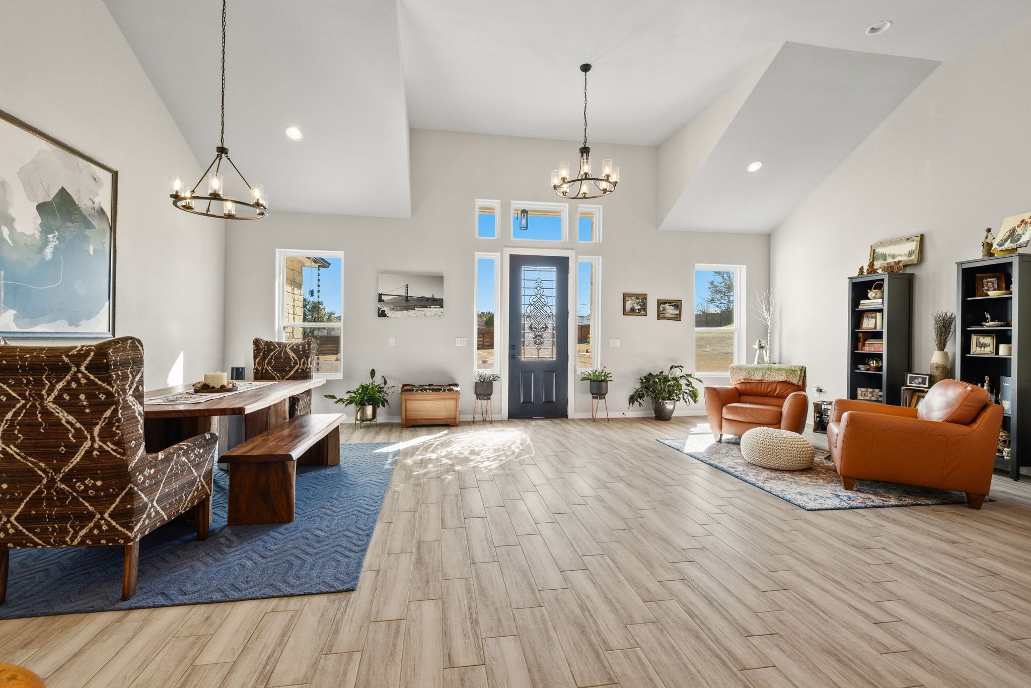 14302 Summit View Drive, Unit 4 Leander, TX 78641 - Photo 4 of 40 Foyer entrance with a chandelier, wood finish floors, and vaulted ceiling
