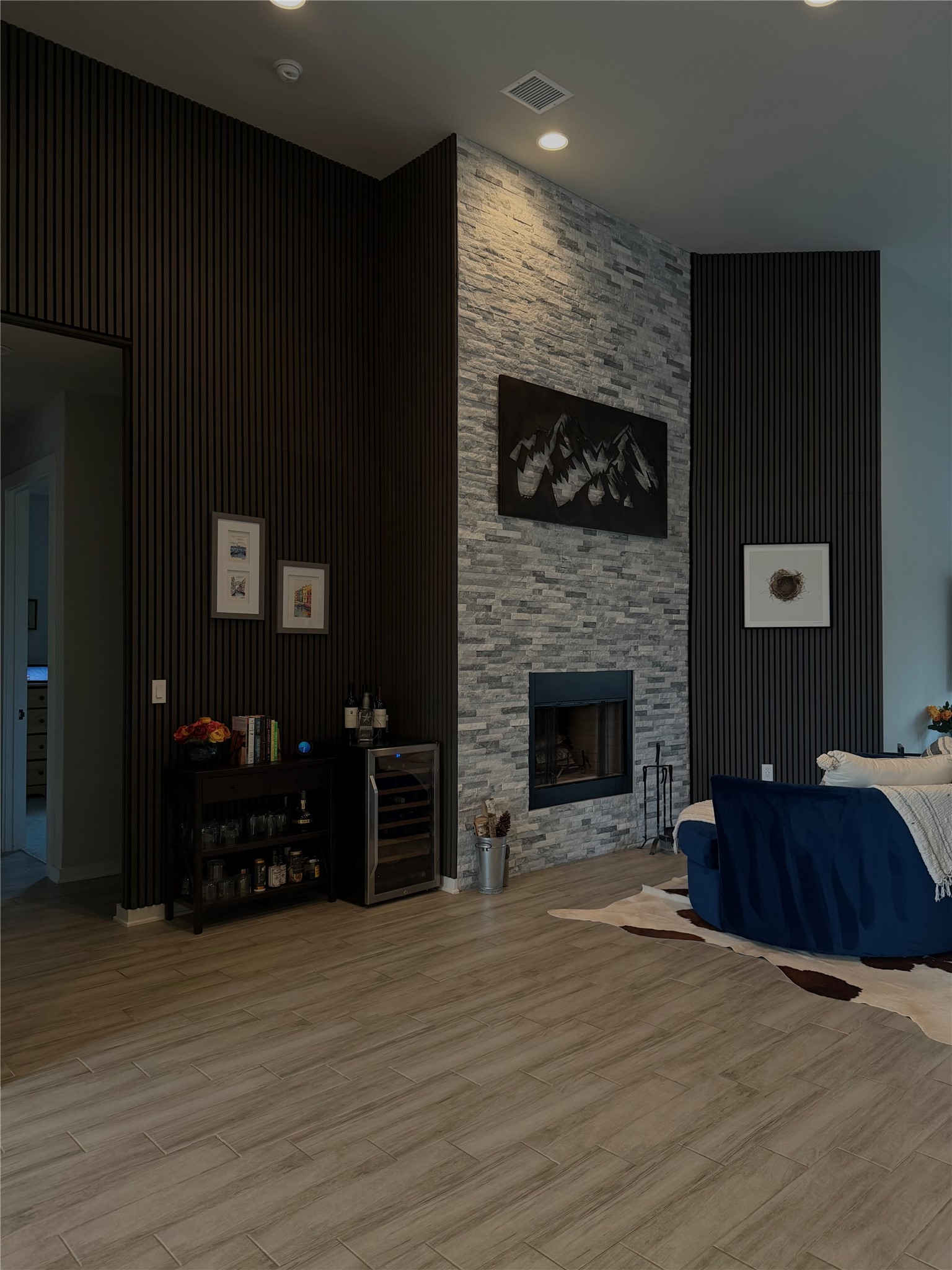 14302 Summit View Drive, Unit 4 Leander, TX 78641 - Photo 5 of 40 Living room with light wood-style floors, wine cooler, and a fireplace