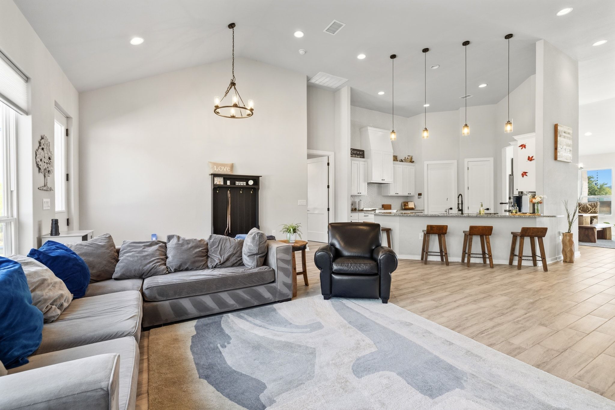 14302 Summit View Drive, Unit 4 Leander, TX 78641 - Photo 6 of 40 Living area featuring light wood finished floors, suspended lighting, and lofted ceiling