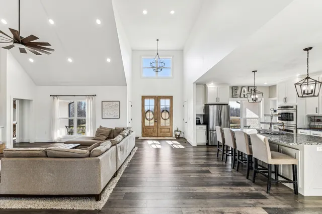 a living room with furniture and wooden floor