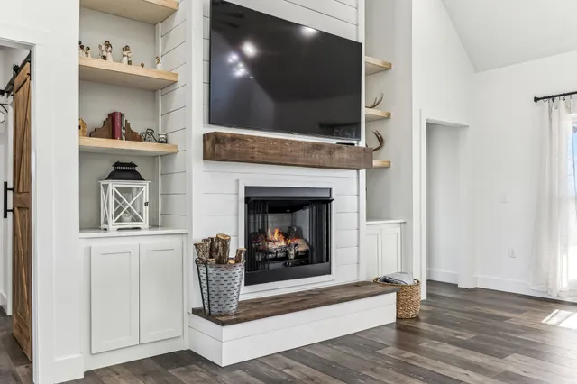 a kitchen with granite countertop white cabinets and stainless steel appliances