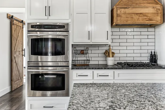 a view of a hallway with wooden floor and entryway