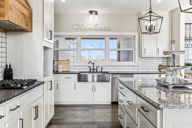 a kitchen with stainless steel appliances granite countertop a stove and a refrigerator