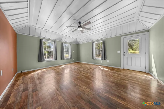 a view of a livingroom with a ceiling fan and window