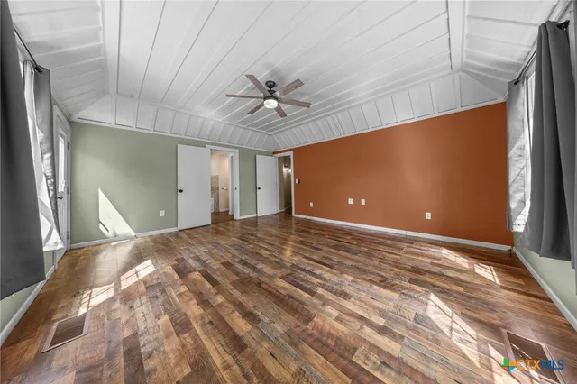 a bathroom with a granite countertop sink and a bathtub