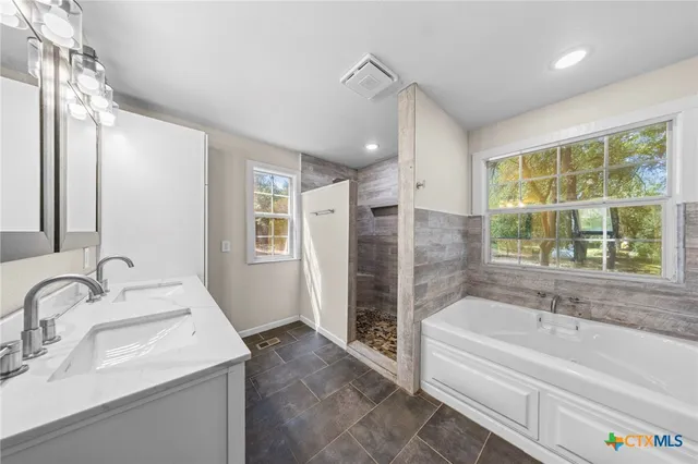 a bathroom with a double vanity sink and a mirror