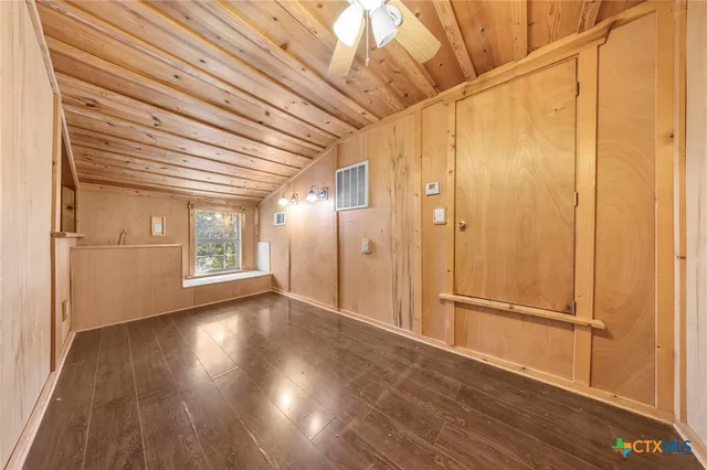 a room with wooden floors and white walls