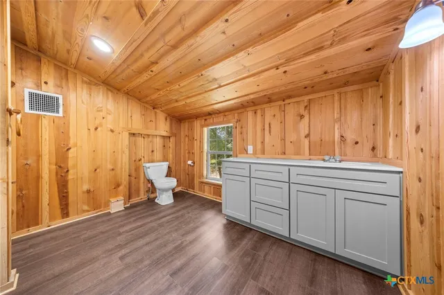 a bathroom with a double vanity sink and shower